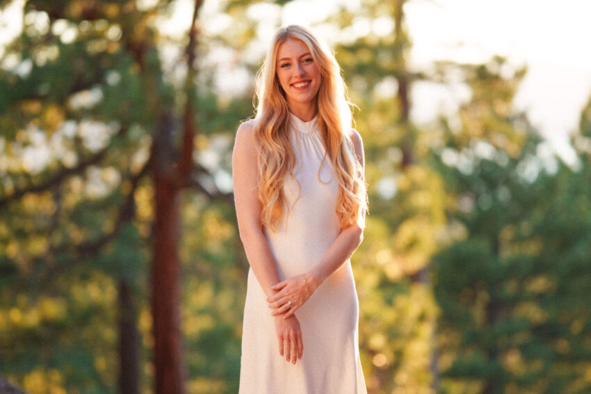 Portrait of a bride with a sunlit forest background.
