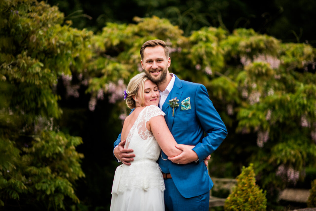 A couple embrace on their wedding day.