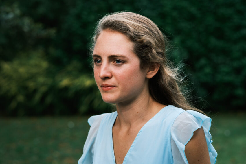 A portrait of a woman in soft daylight.