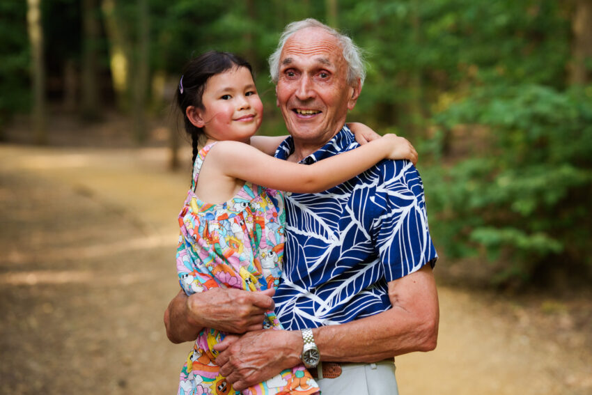 Girl and her grandfather photographed in a woodland area on 85mm lens.