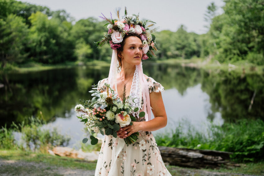 Three-quarters length portrait of a bride wearing a Ukrainian bridal headdress.