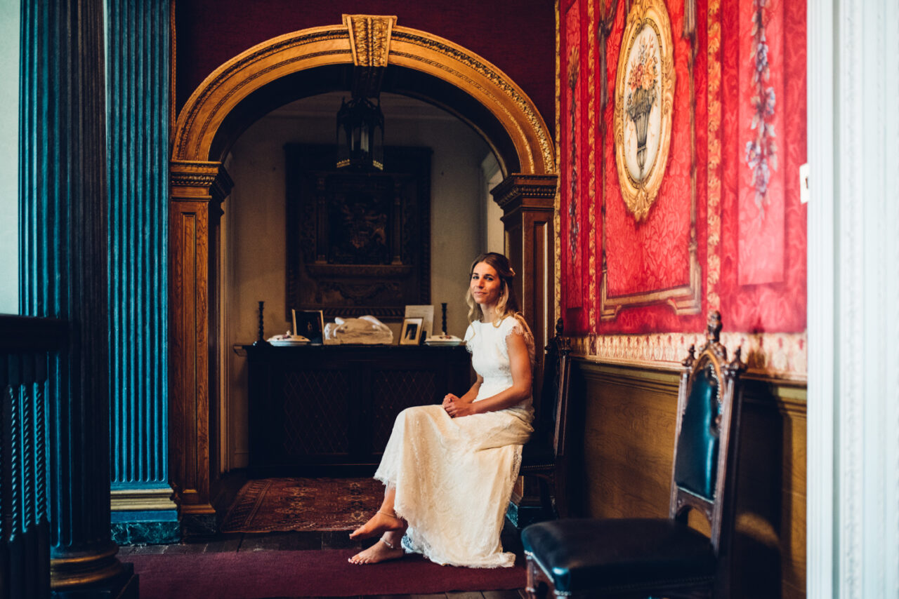 A bride sits on a chair before the wedding ceremony at Island Hall.