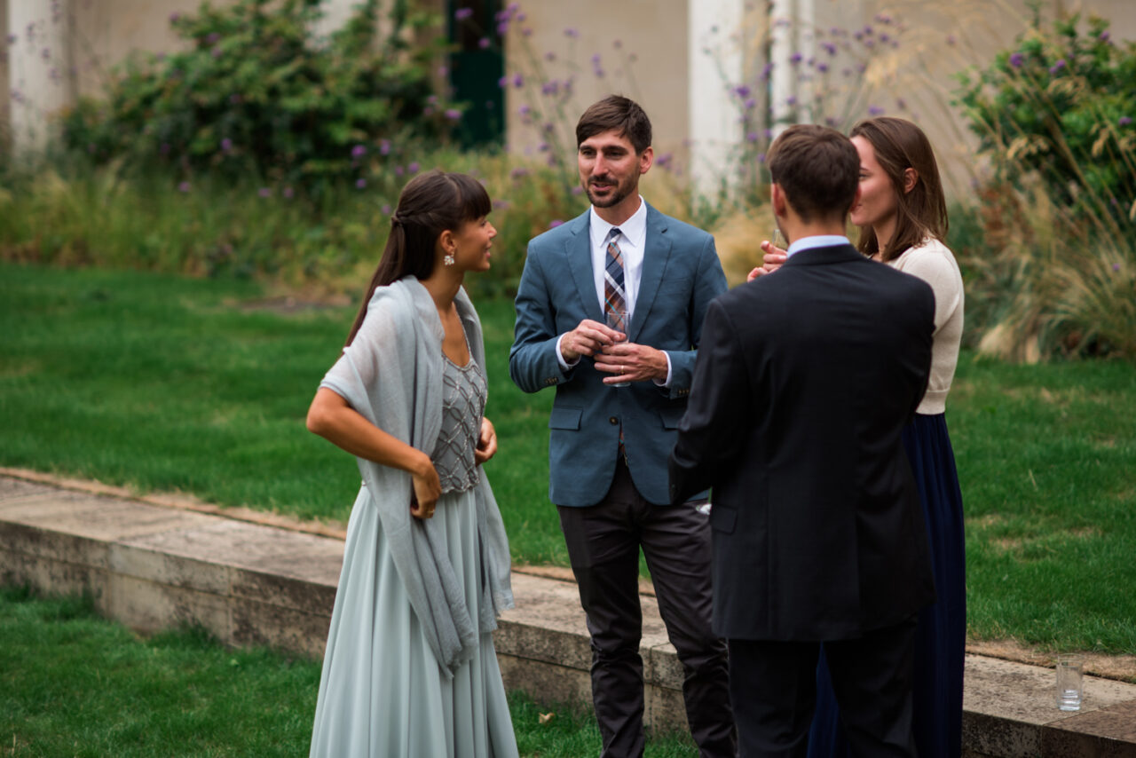 Wedding guests talk at Downing College.