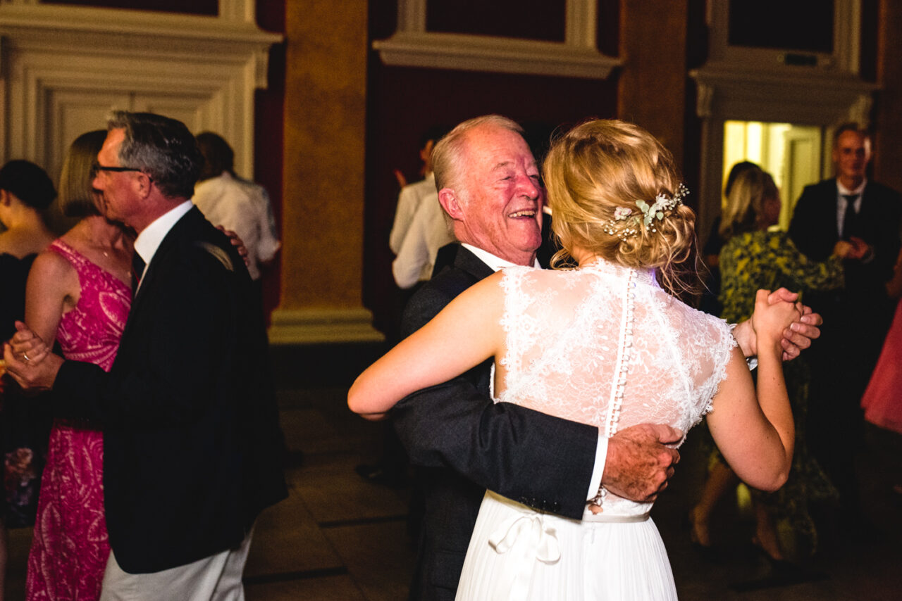 Bride and grandfather dance together.