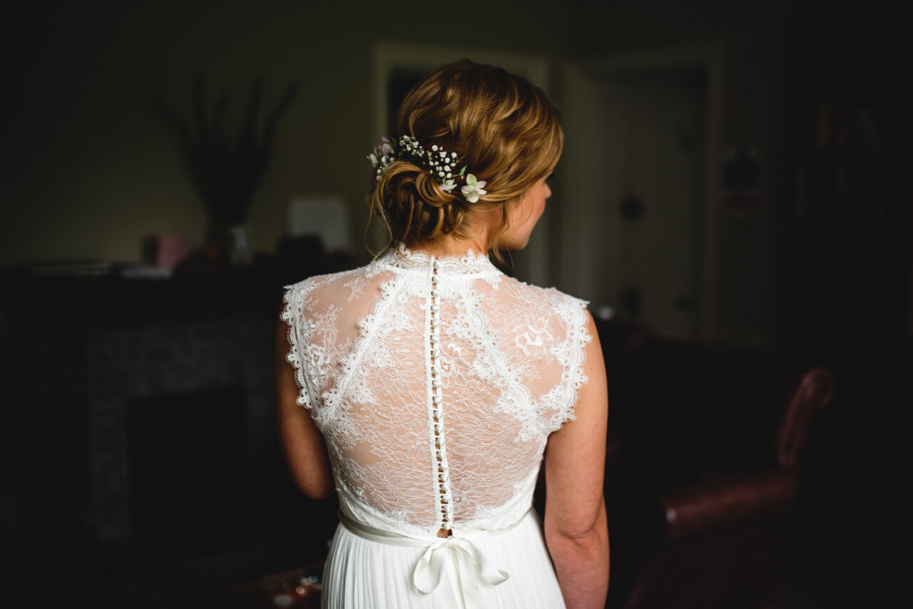 The back of a bride's wedding dress.