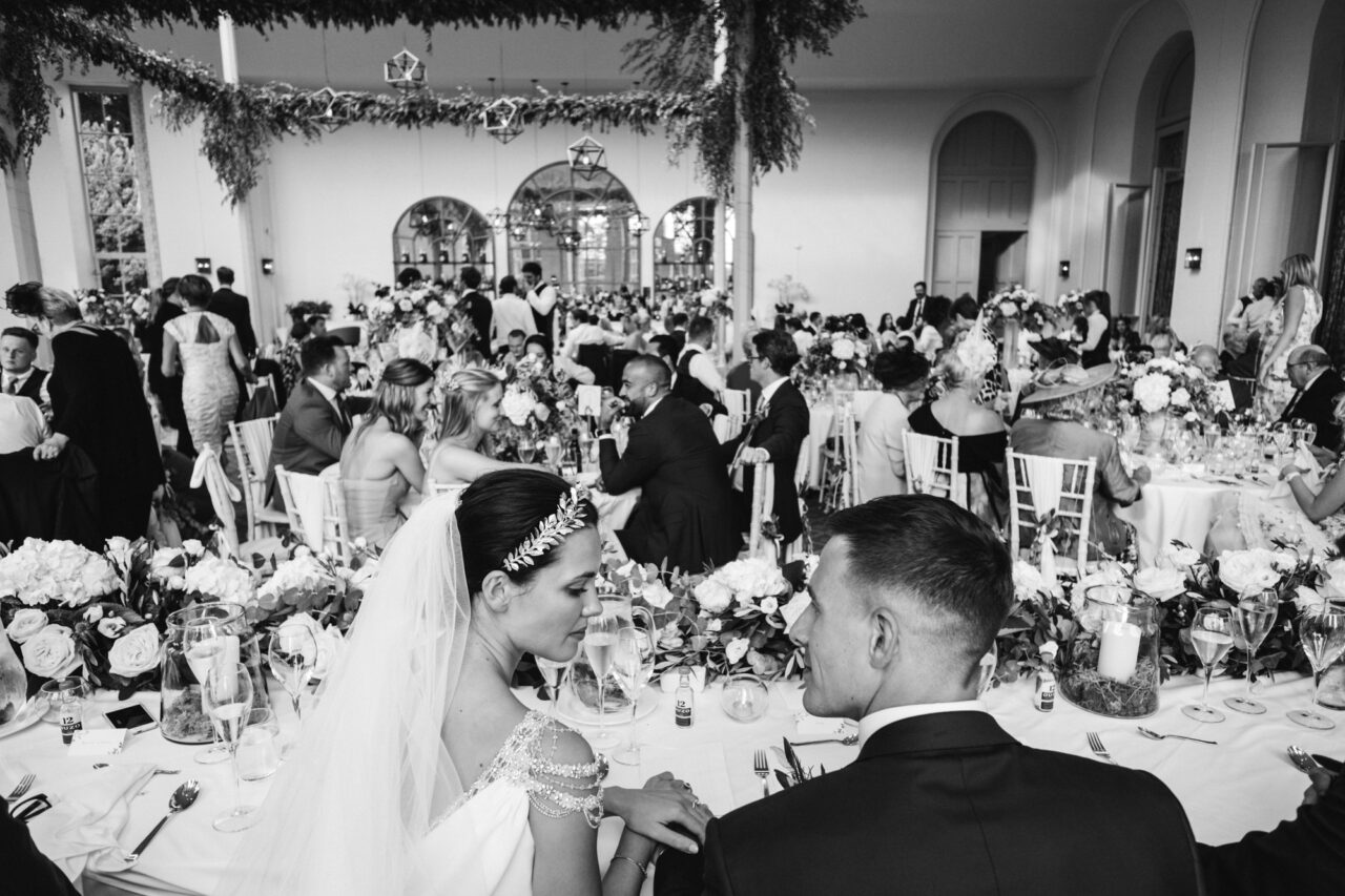 Documentary wedding photography. A bride and groom sit at their table during a wedding at Wynyard Hall.