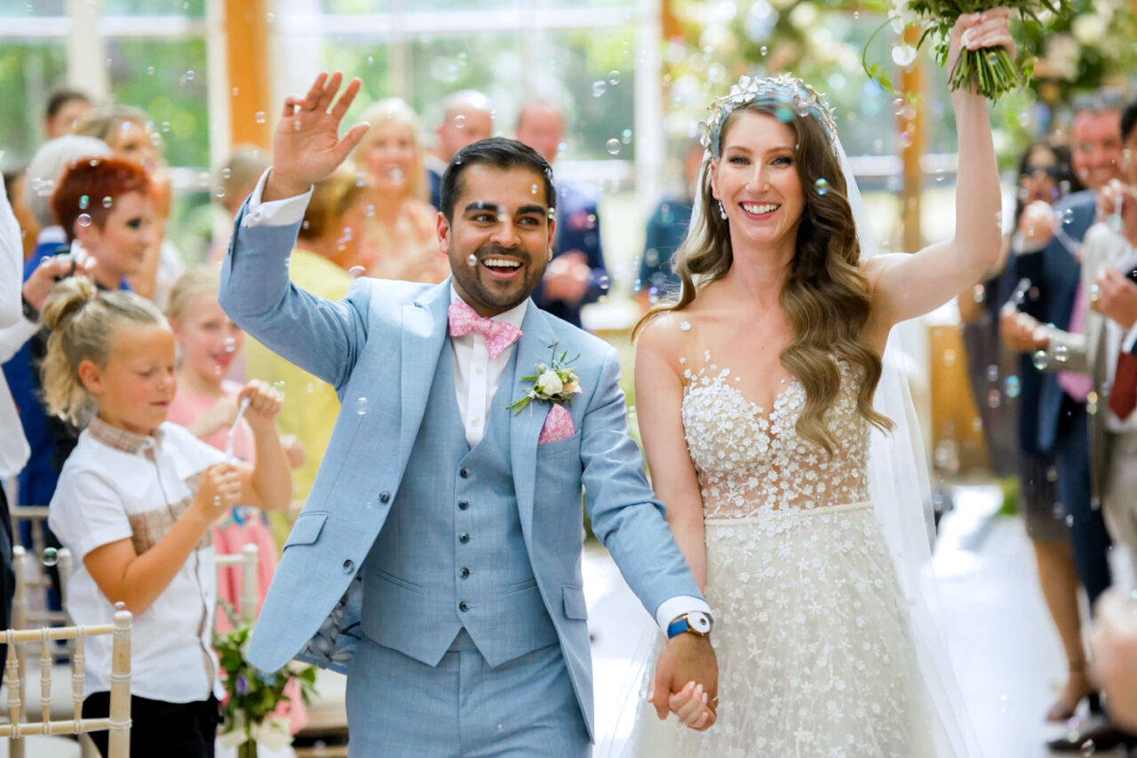 Kew Gardens Weddings - Bride and groom leave their ceremony holding hands in the Nash Conservatory.