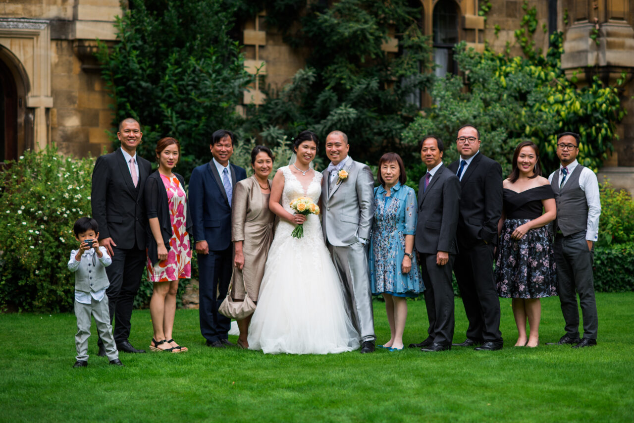 A family wedding photo taken in the gardens at Pembroke College in Cambridge.