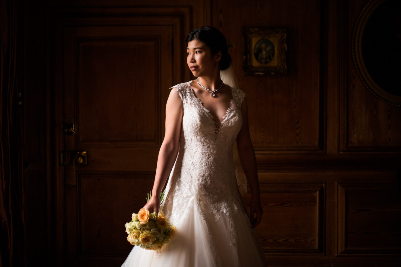 Bride in beautiful window light in Pembroke College.