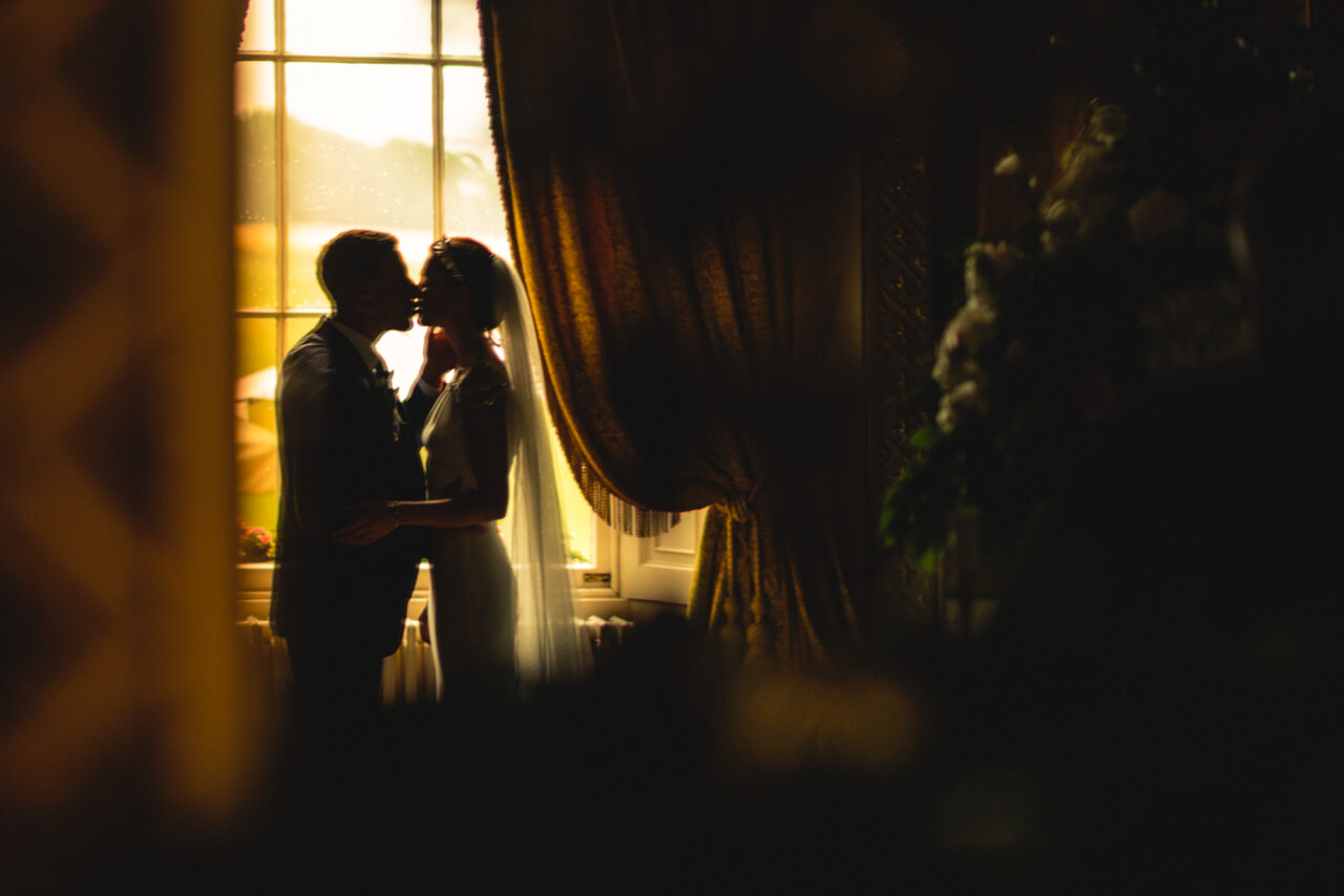 Wynyard Hall Wedding Photographer - A bride and groom reflected in a mirror inside Wynyard Hall.