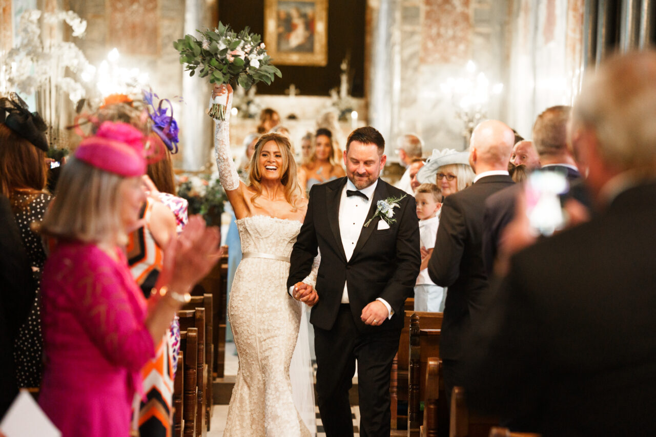 Wynyard Hall Wedding Photographer - A bride and groom walk up the aisle after their wedding ceremony in the chapel at Wynyard.