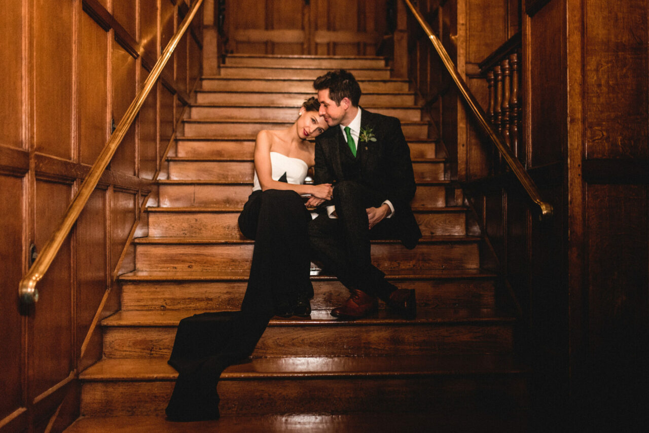 Wedding photo of a couple on the stairs at Gonville and Caius.