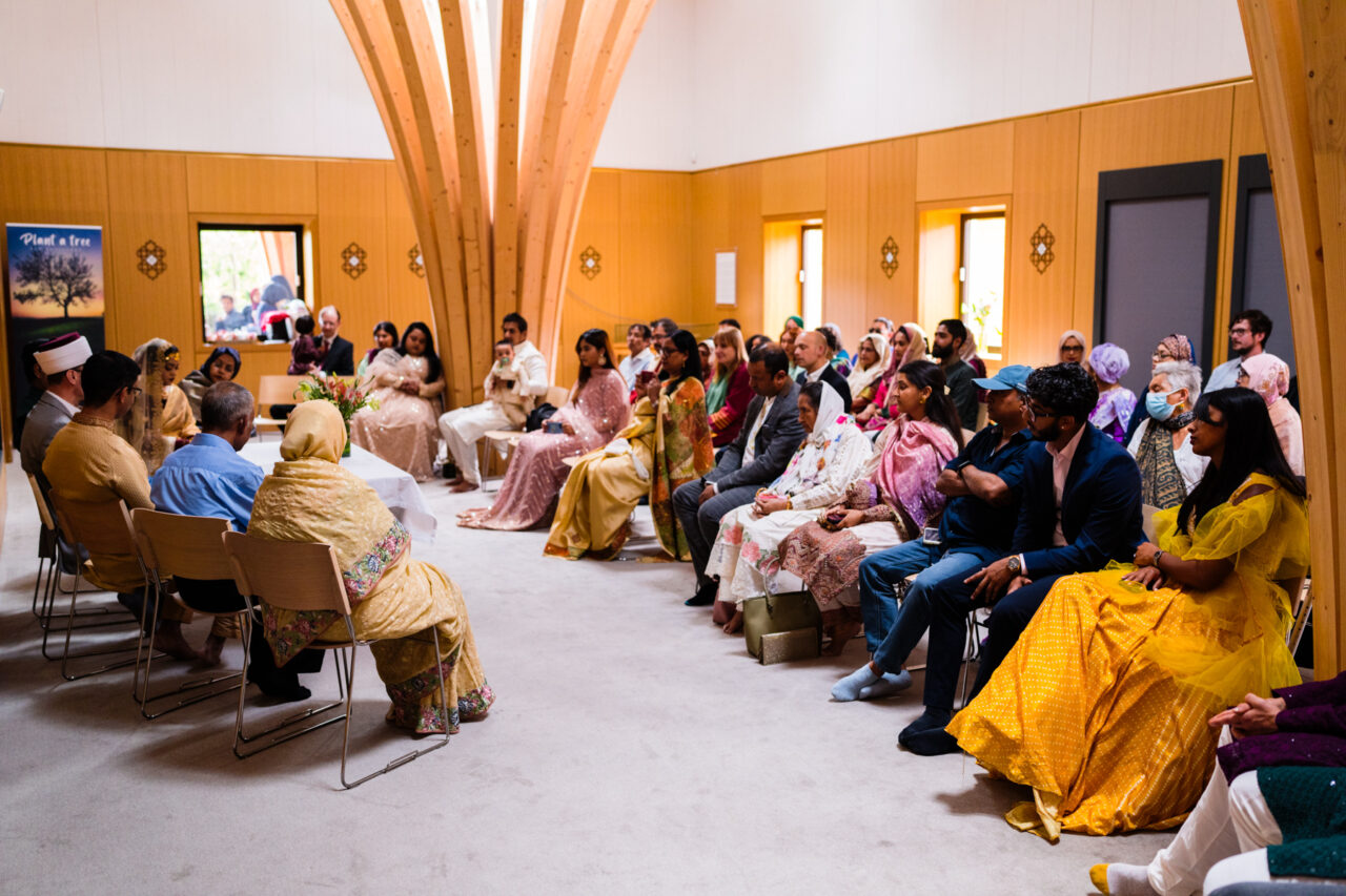 A wide photo of a Nikah ceremony at Cambridge Central Mosque on Mill Road.