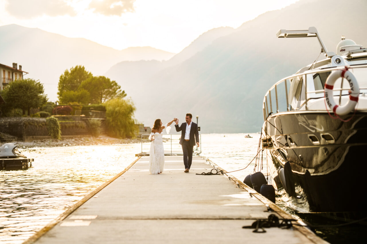 Bride and groom holding hands in the sunset after their Lake Como elopement.