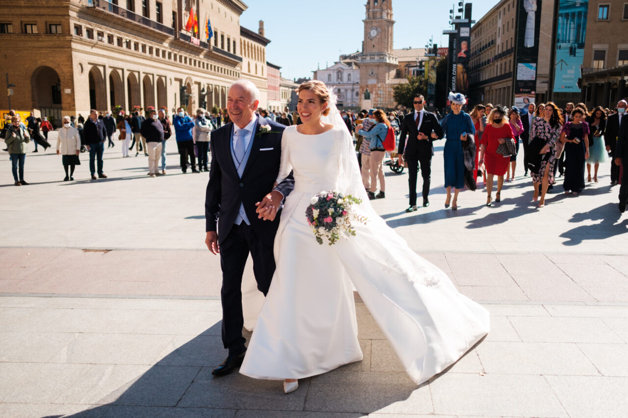 A bride and her father walking to her wedding.