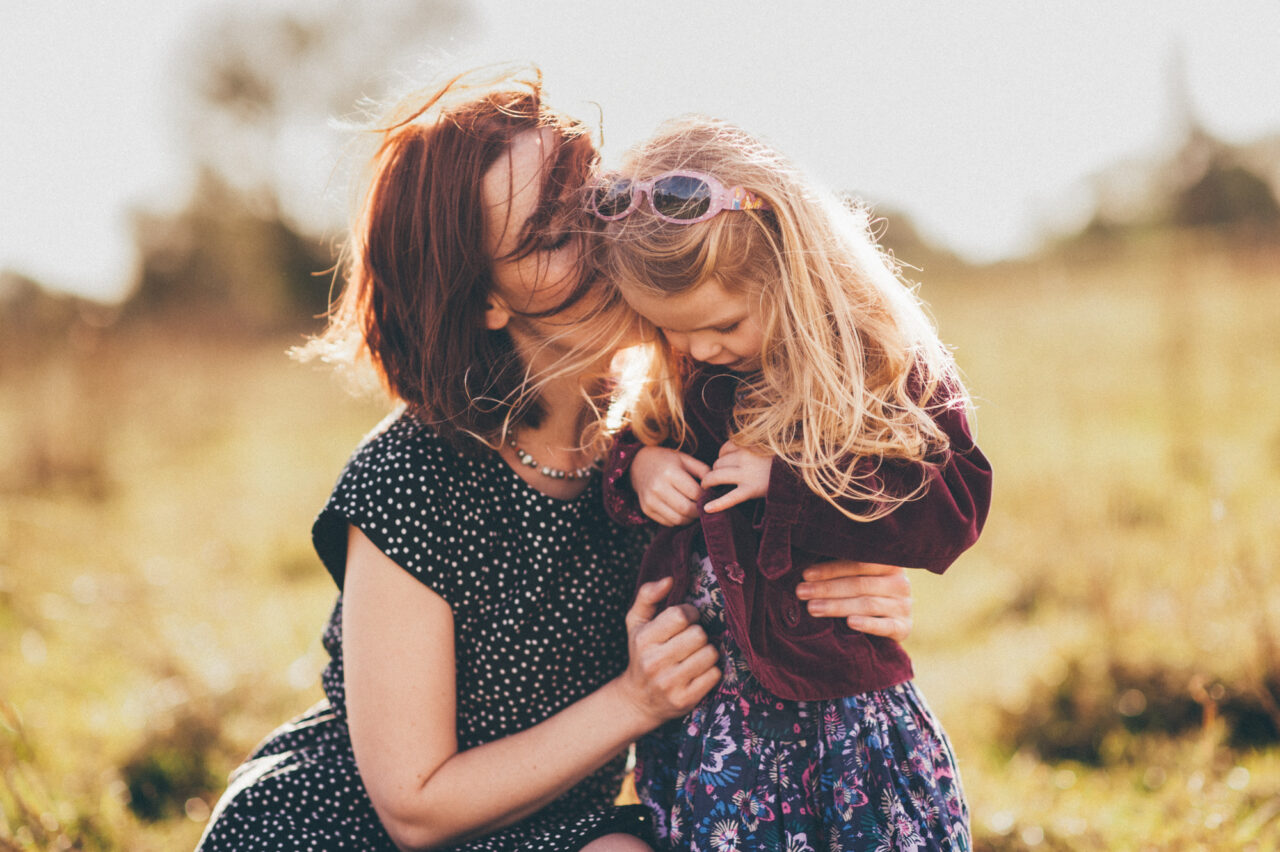 Family photography of mother and child embracing.