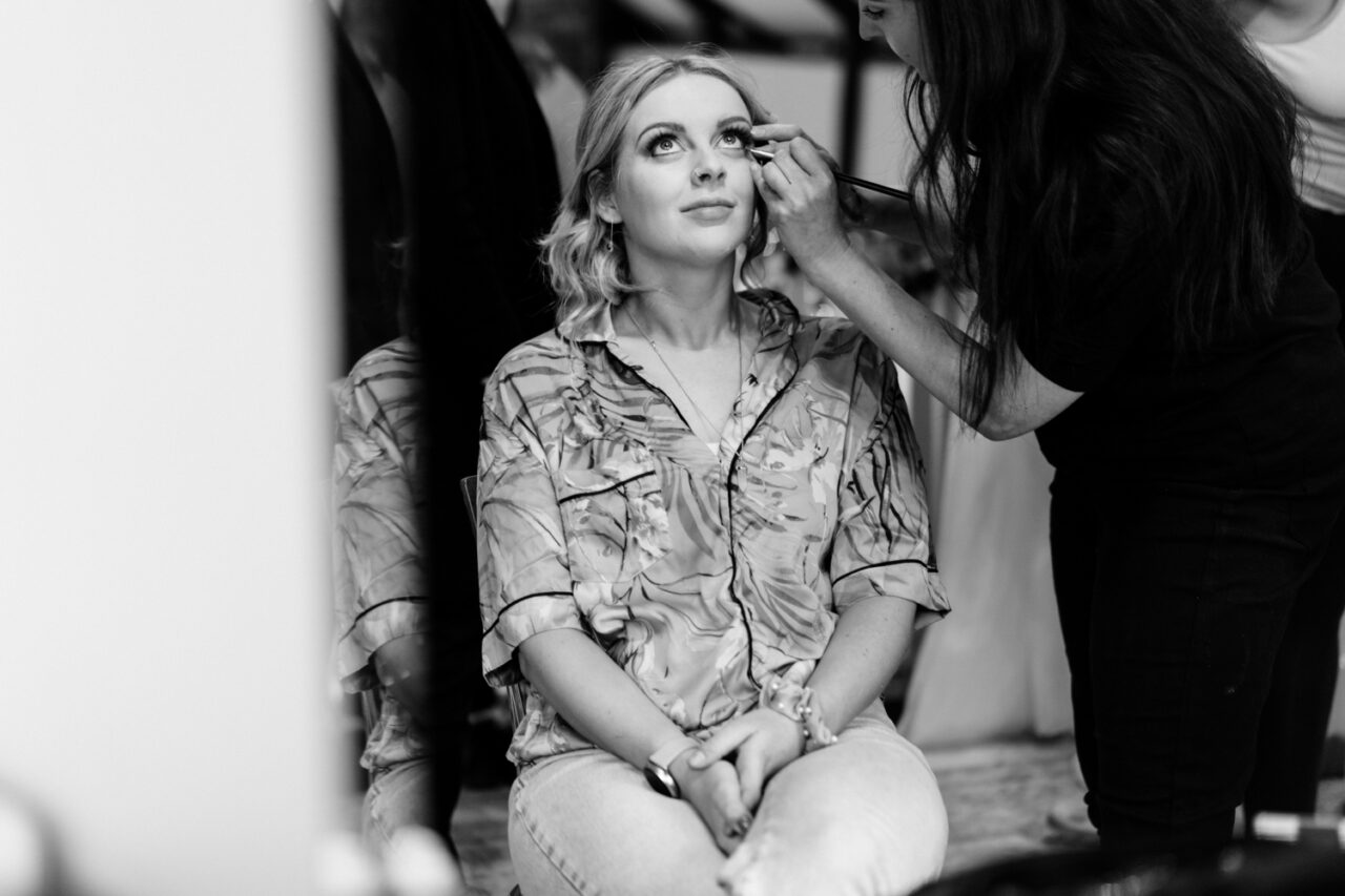 A bridesmaid getting ready at Hockwold Hall.