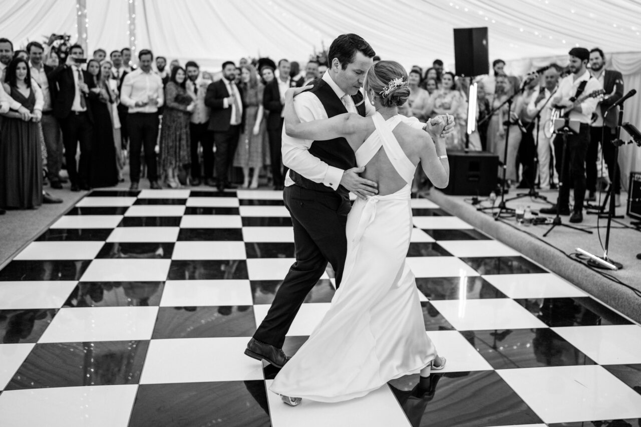 A couple dancing their first dance in the marquee at Longstowe Hall near Cambridge.