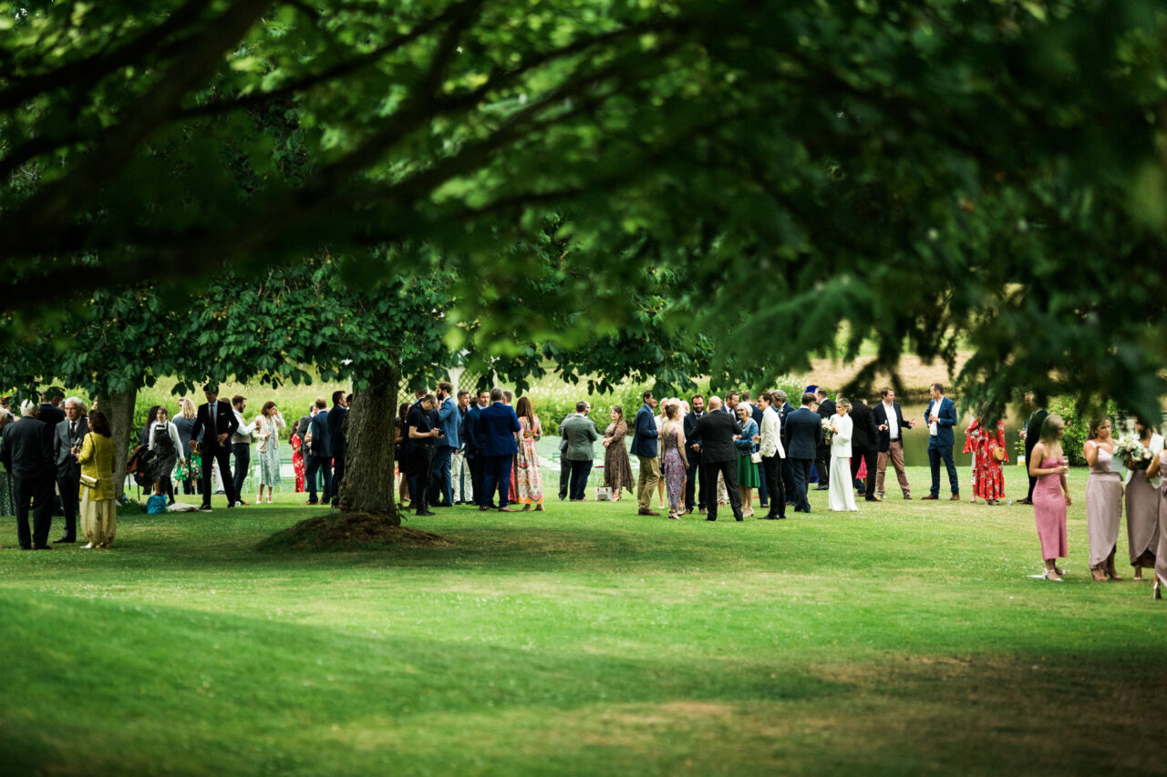 Wedding guests on the garden of Longstowe Hall.