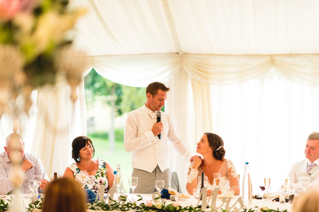 The groom looks into the eyes of the bride during his speech at Longstowe Hall.