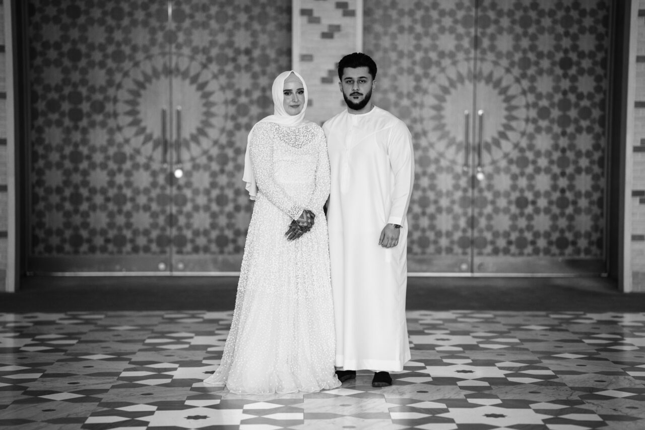 Bride and groom standing inside Cambridge Central Mosque.