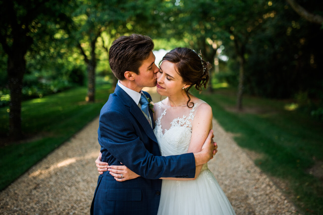 A bride and groom embrace on their wedding day.