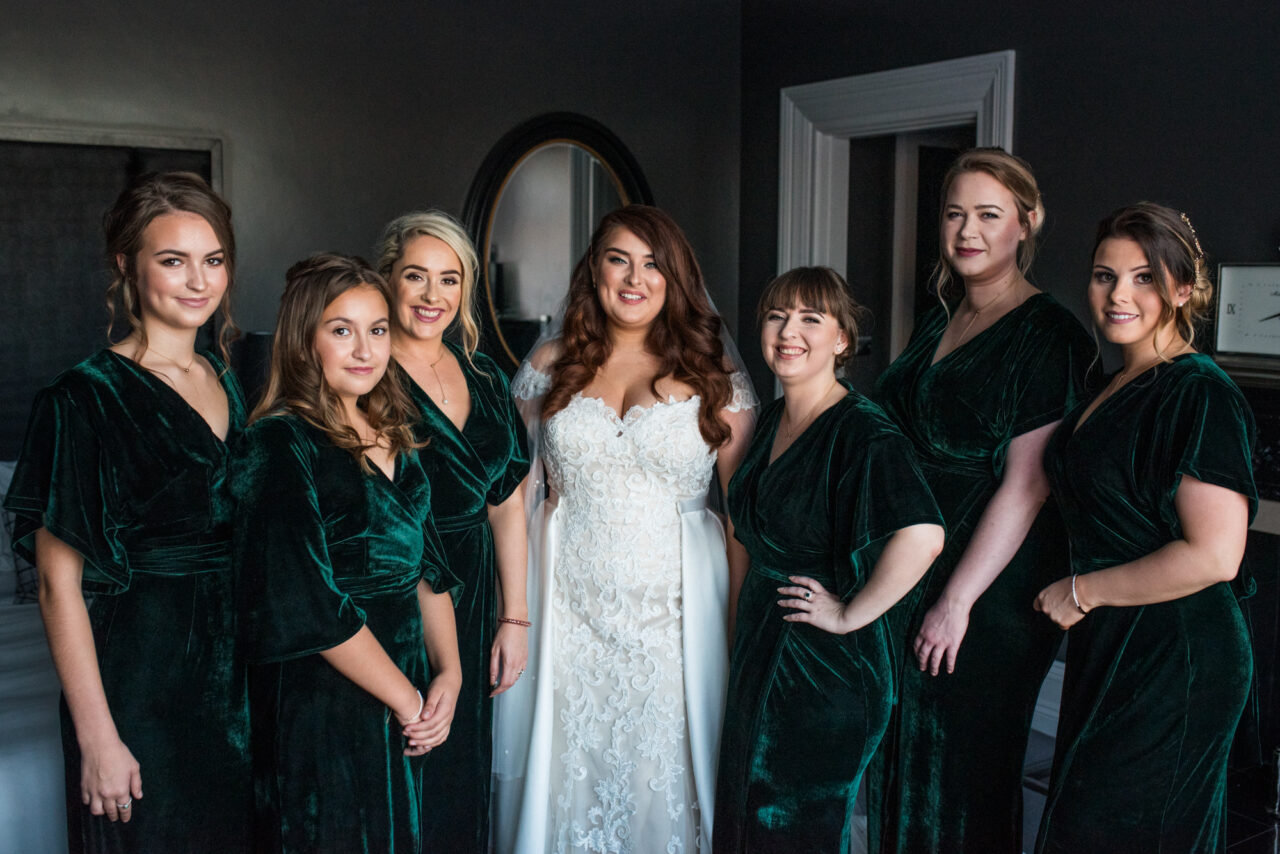 A bride and her bridesmaids pose for a photograph in Swynford Manor.