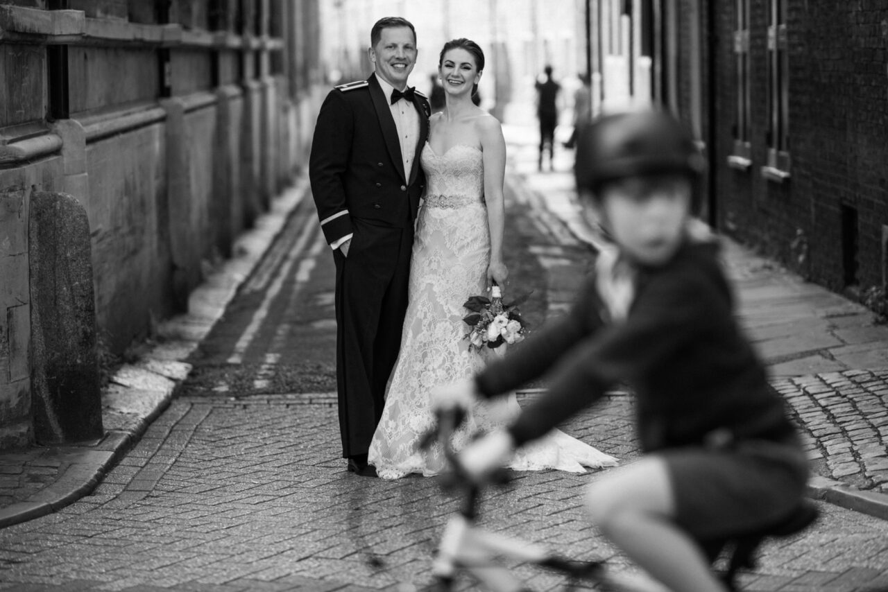 A couple pose for pre-wedding photos on Trinity Lane in Cambridge.