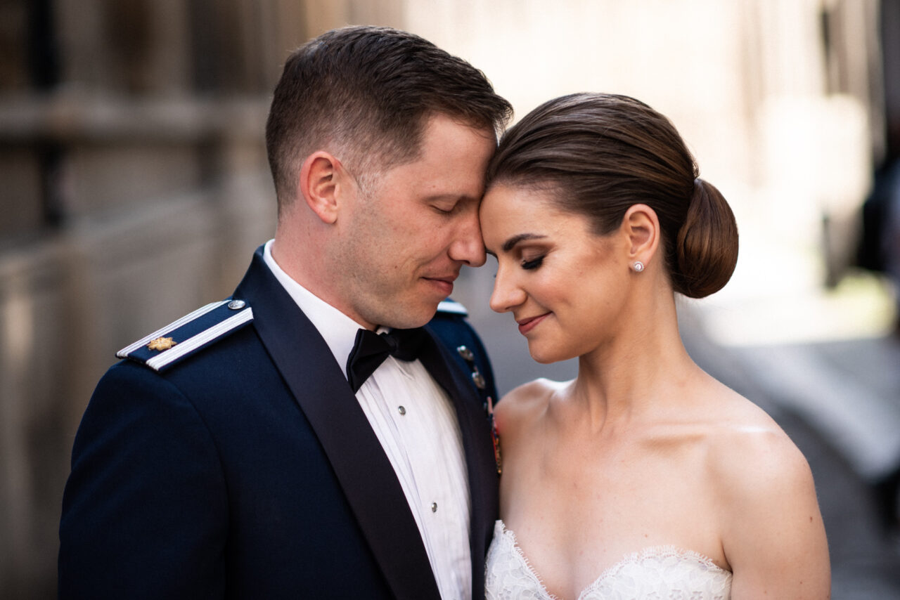 A couple pose for pre-wedding photos on Trinity Lane in Cambridge.