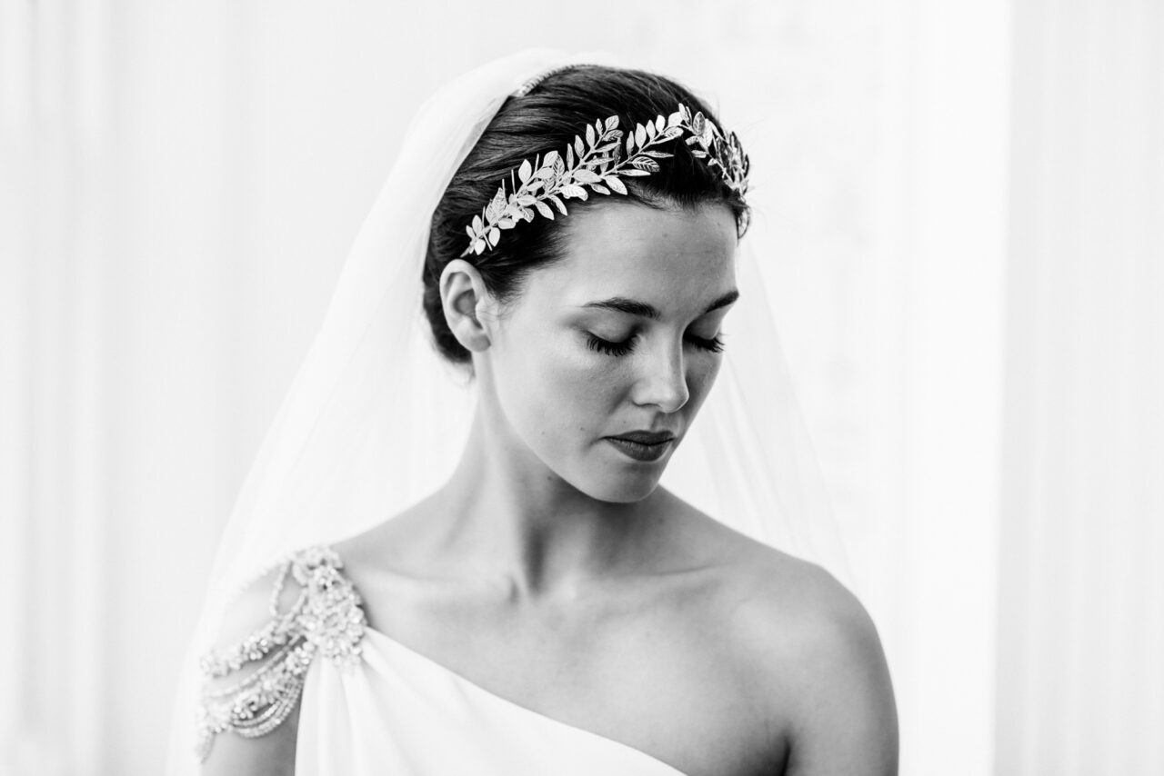 Black and white wedding photo of a bride wearing a silver headdress.