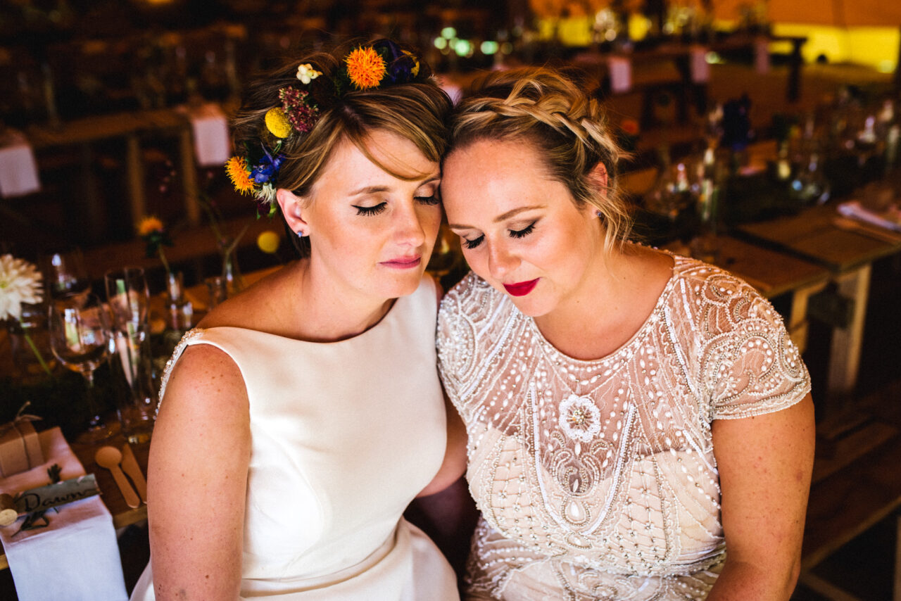 Two brides embracing on their wedding day in Cambridgeshire.