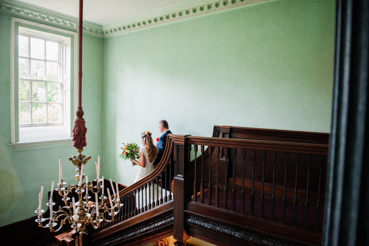 Bride and her father walking down the stairs at Island Hall.