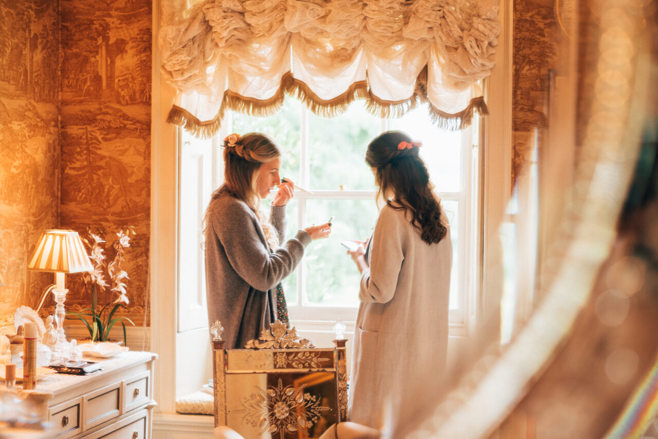 A bride and bridesmaid get ready for a wedding at Island Hall.