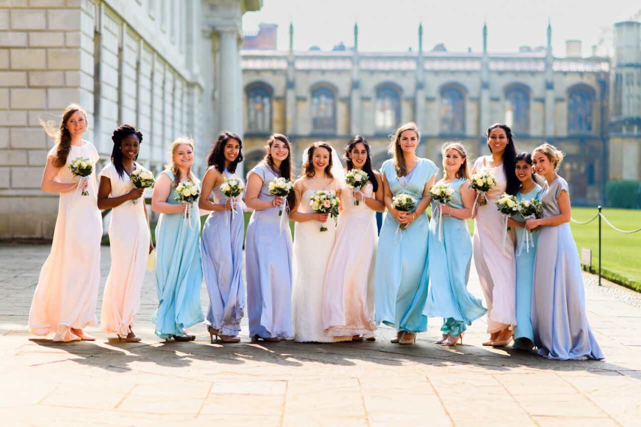 A bride with 11 bridesmaids outside King's College Chapel.