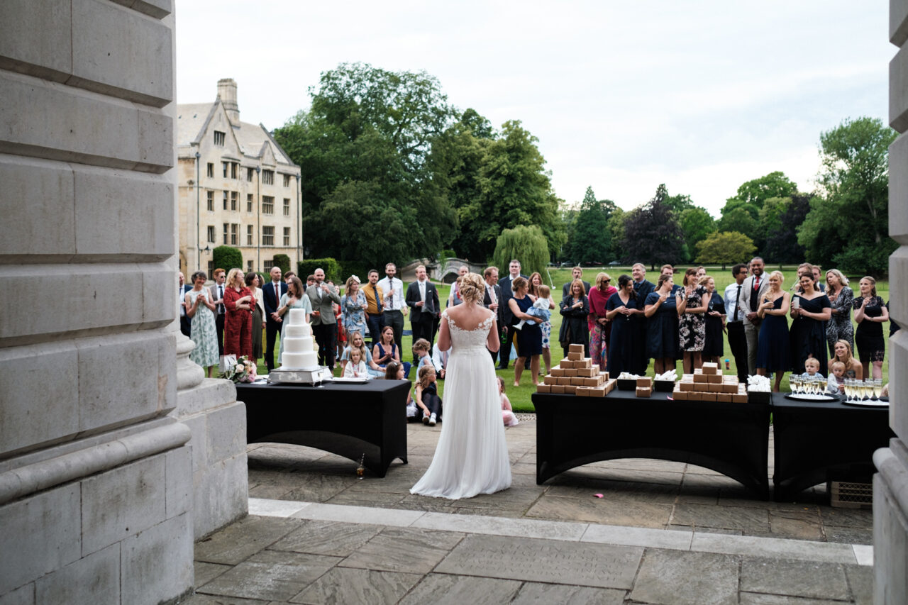 A bride gives a speech outside in the grounds of King's College in Cambridge.