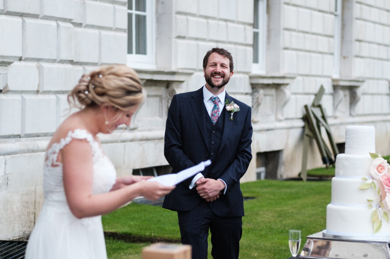 A bride gives a speech outside in the grounds of King's College in Cambridge.