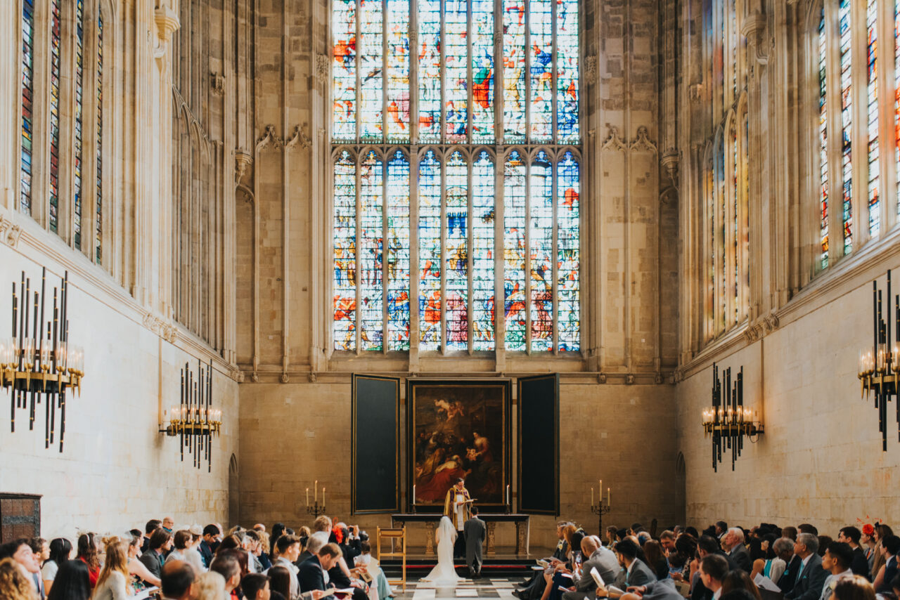 A wide view of a wedding service in King's College Chapel in Cambridge.