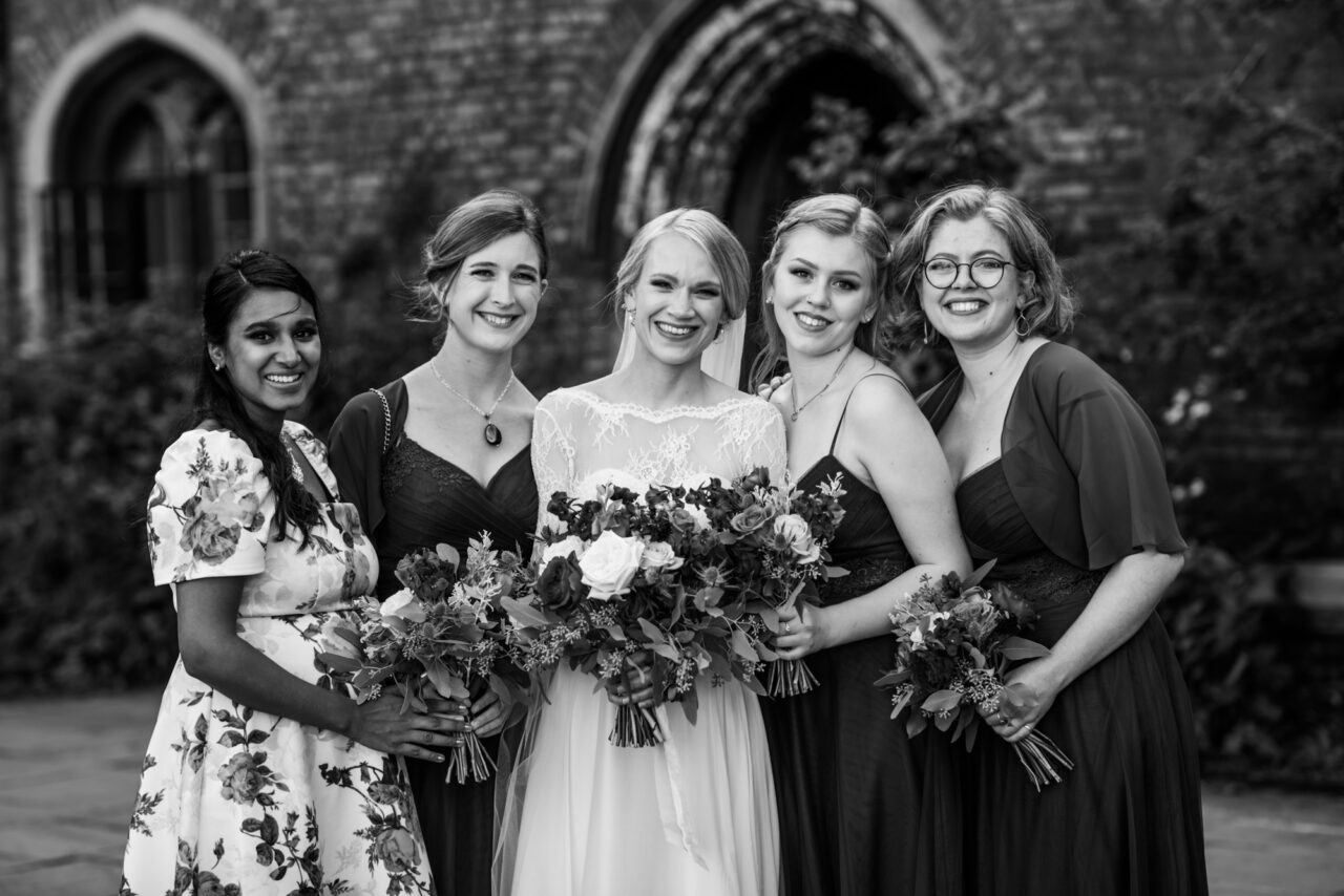 Group wedding photo at Queens' College in Cambridge.