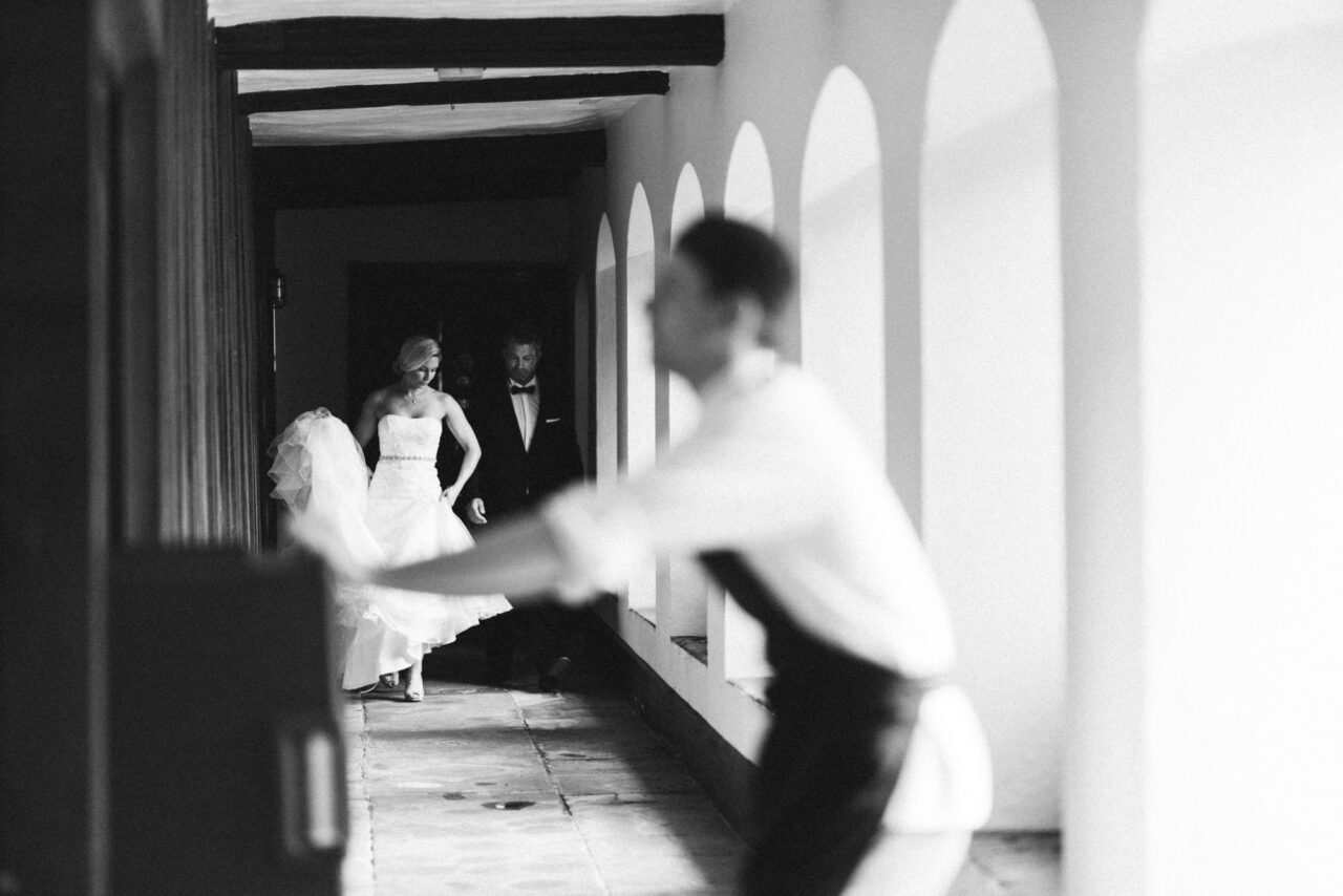 Bride and groom in the cloisters at Queens' College.