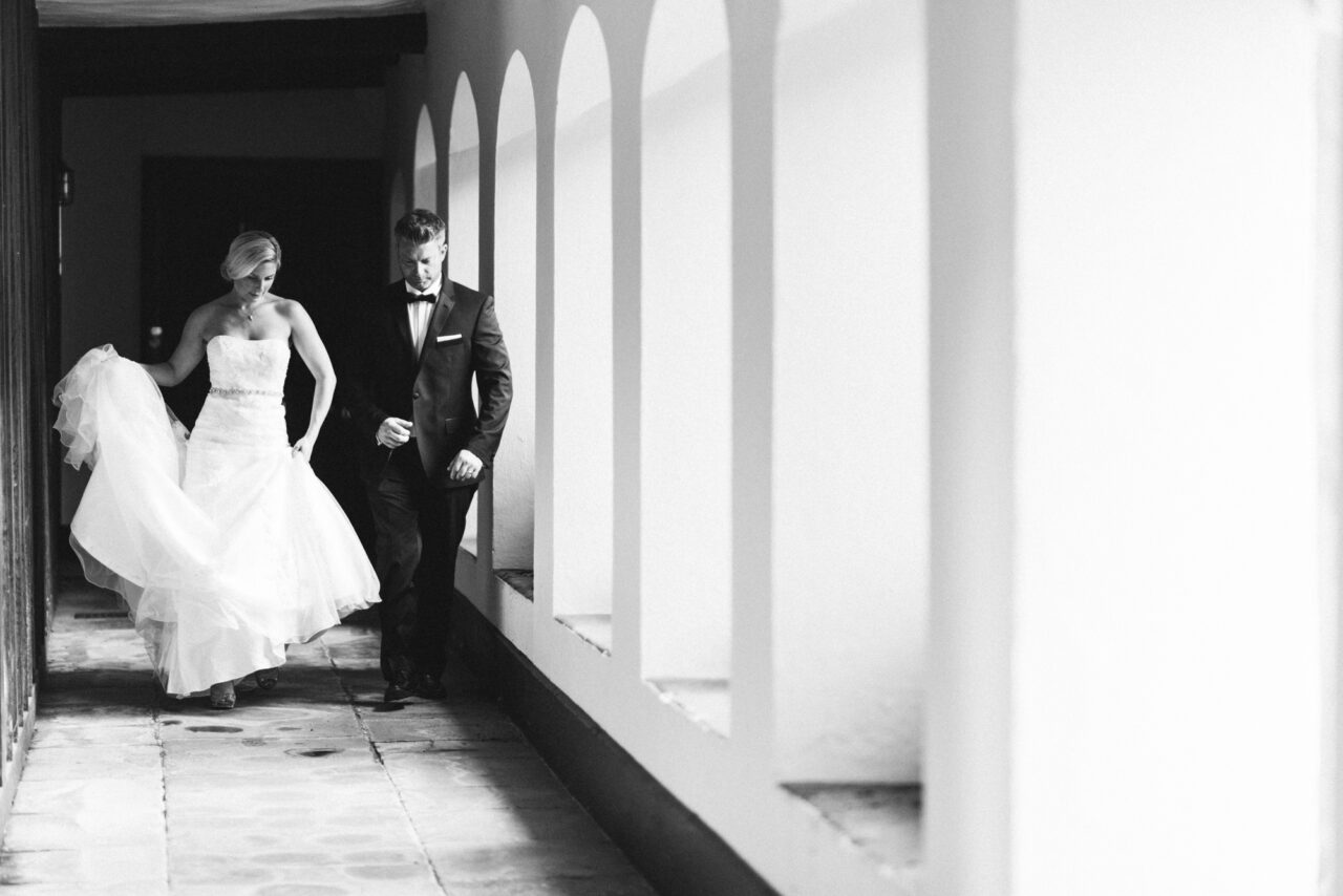 Bride and groom in the cloisters at Queens' College.