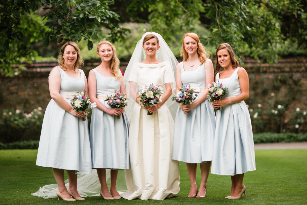 Group wedding photo at Queens' College in Cambridge.