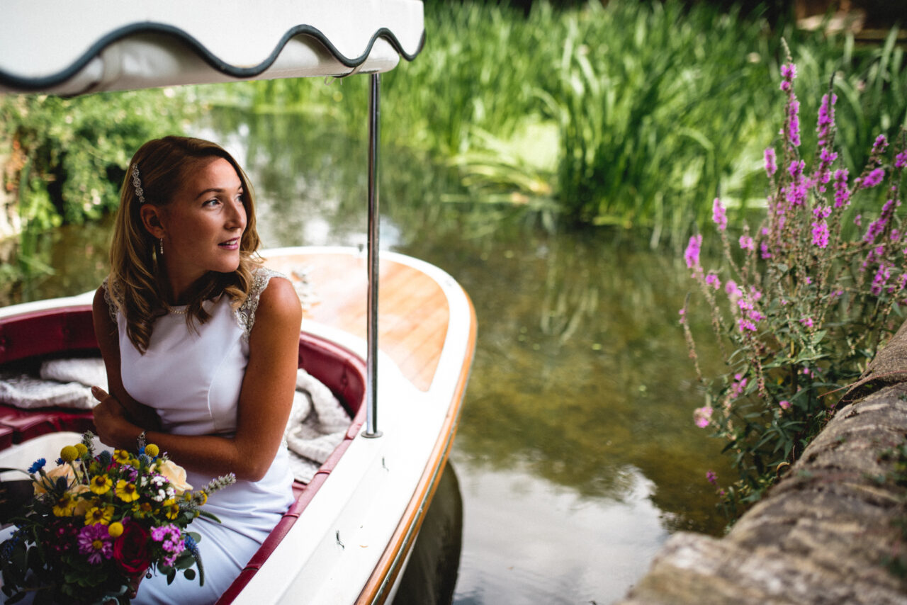 A bride arrives for her wedding on a boat.