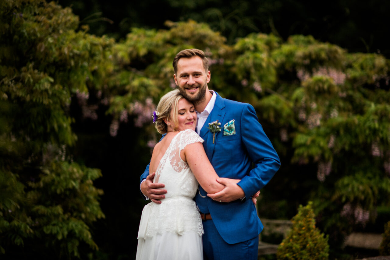 A bride and groom embrace on their wedding day in St Ives.