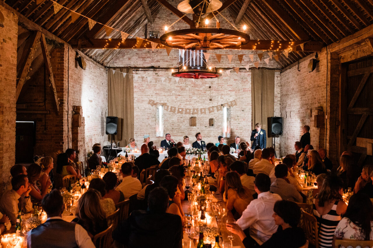 The barn at at Burleigh Hill Farm in St Ives filled with people for a wedding.