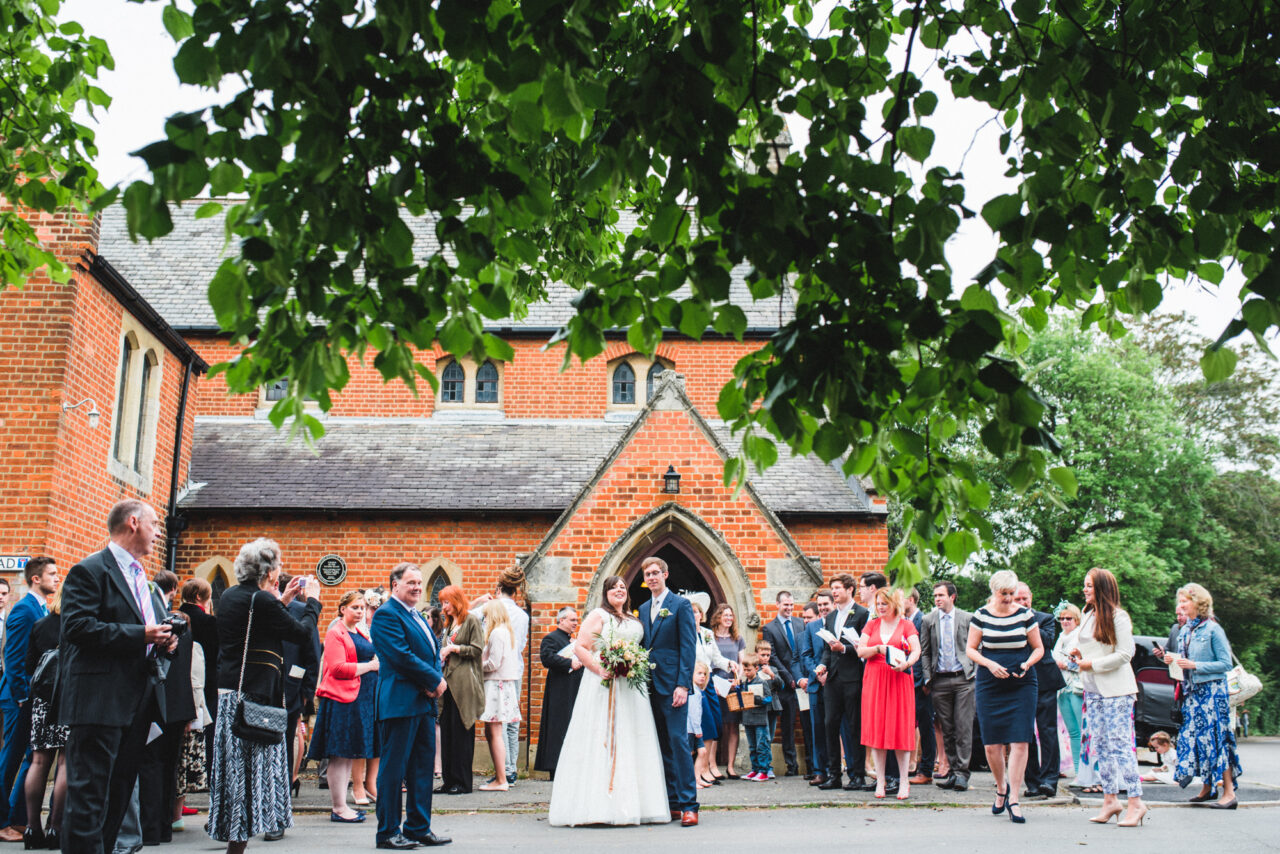 Bride and groom outside Sacred Heart Catholic Church in St Ives, Cambridgeshire.