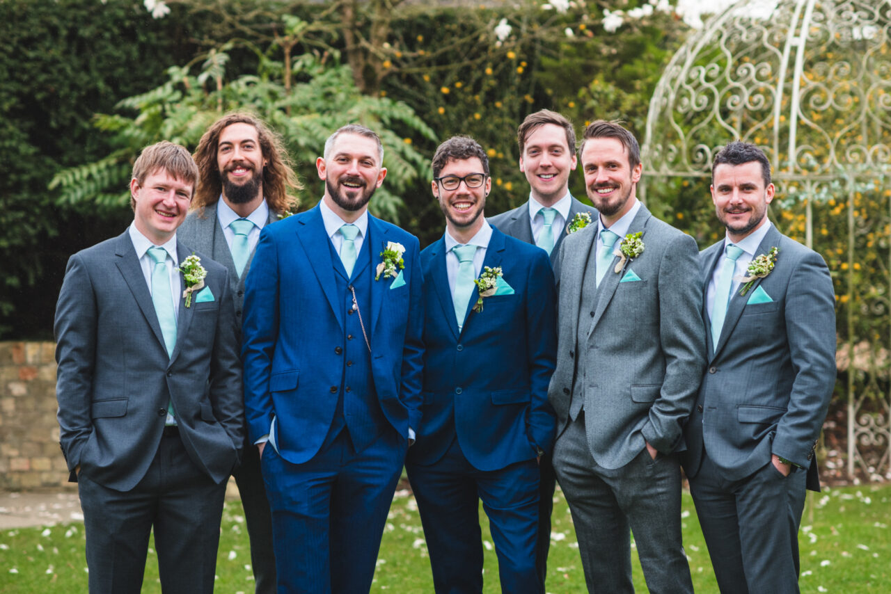 Groomsmen pose outside at Slepe Hall in St Ives, Cambridgeshire.