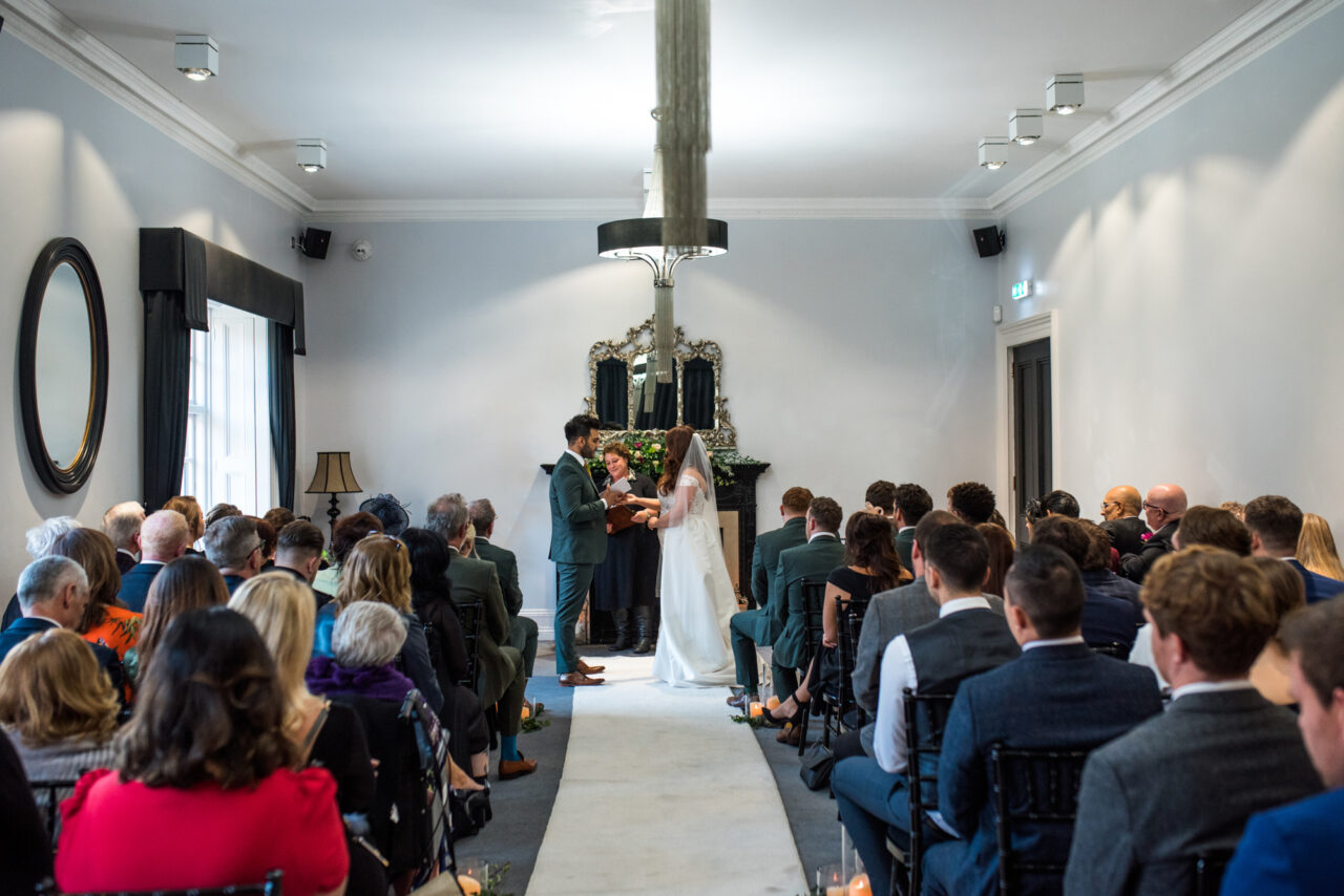 An indoor wedding ceremony in The Study at Swynford Manor.