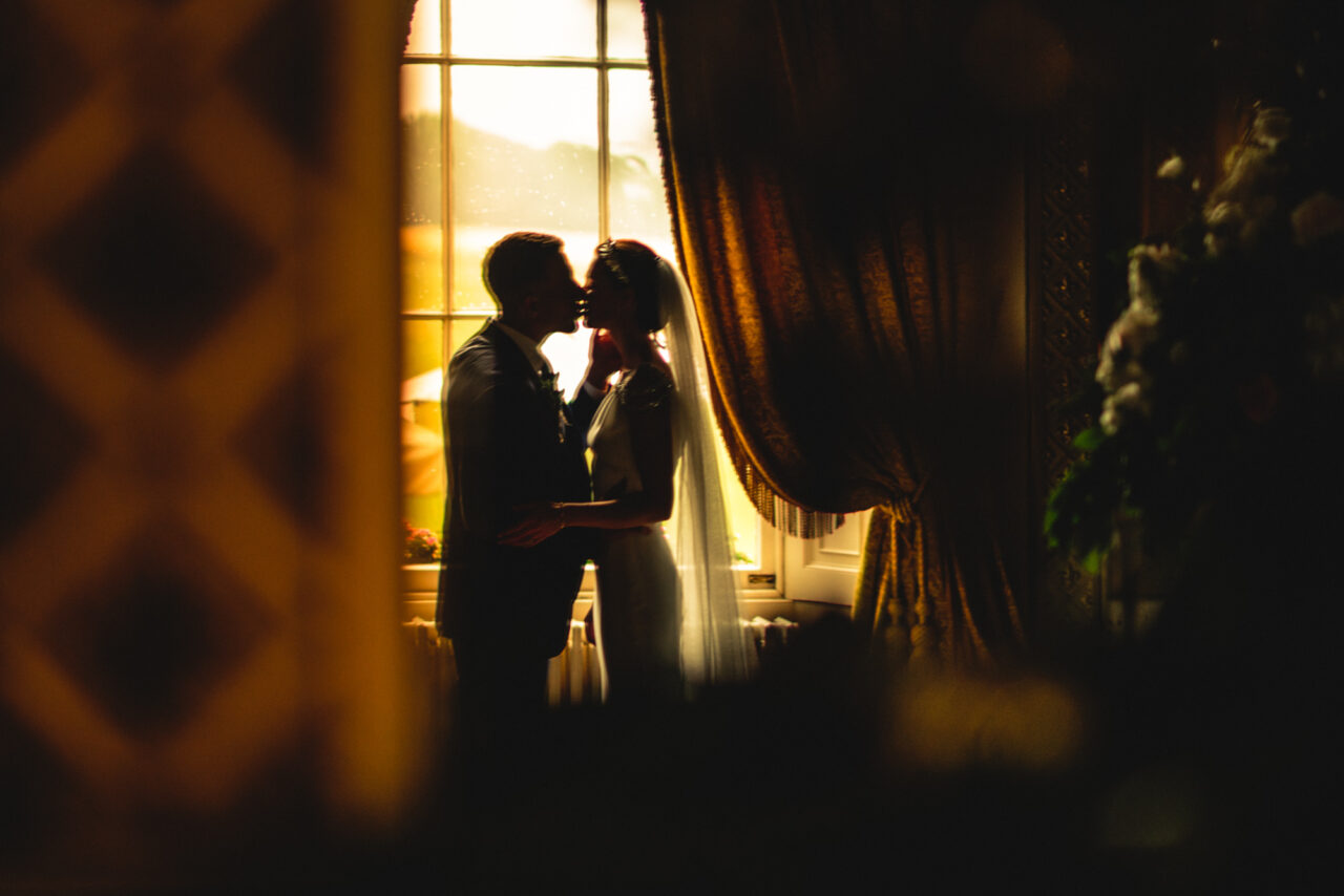 Jewish wedding videography of bride and groom kissing.