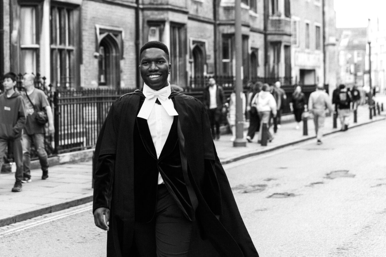 A new Cambridge graduate walks across King's Parade in Cambridge.
