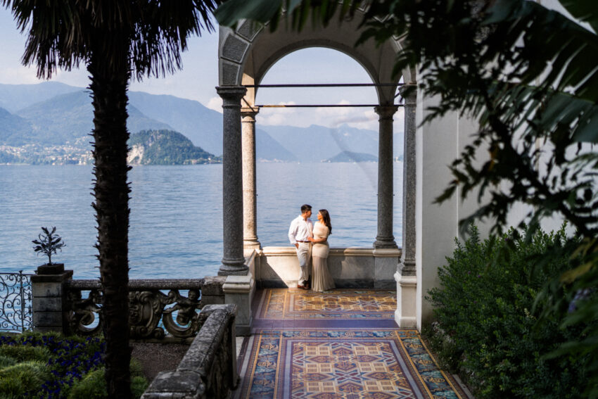 Couple embrace in the sun at Villa Monastero, Italy.